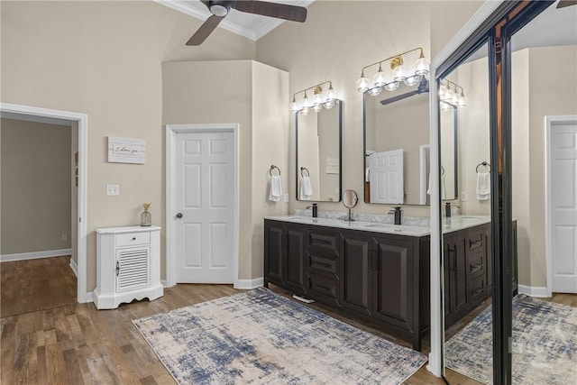 139 Mingarry Dr, Richmond Hill, GA 31324 - bathroom with ornamental molding, ceiling fan, wood finished floors, and double vanity