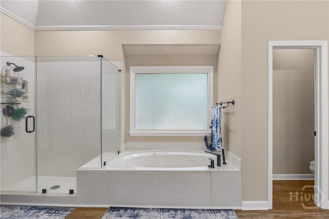 139 Mingarry Dr, Richmond Hill, GA 31324 - full bath with a shower stall, wood finished floors, a bath, and a textured ceiling