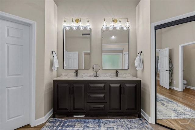 139 Mingarry Dr, Richmond Hill, GA 31324 - full bathroom with double vanity and wood finished floors