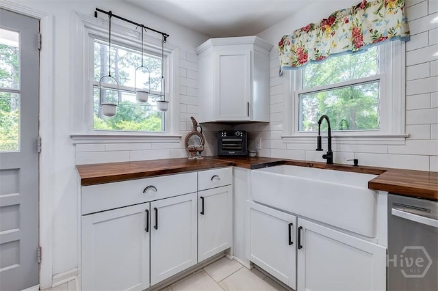 2338 Lorraine Dr, Savannah, GA 31404 - kitchen with butcher block countertops, dishwasher, decorative backsplash, and plenty of natural light