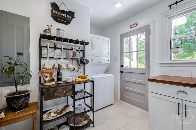 2338 Lorraine Dr, Savannah, GA 31404 - washroom featuring stacked washing machine and dryer and light tile patterned flooring