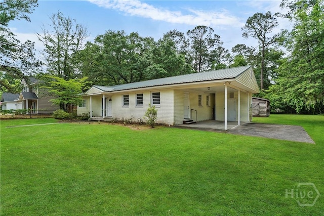129 Vandiver Rd, Walthourville, GA 31301 - rear view of property with a lawn, an attached carport, asphalt driveway, and a metal roof