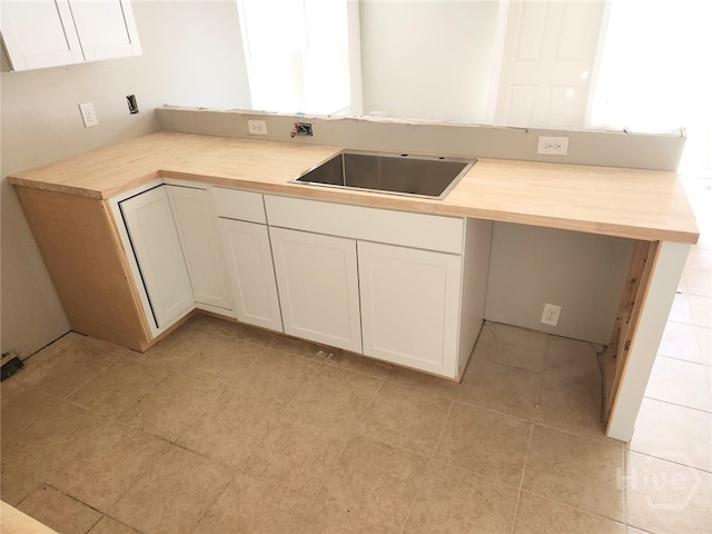 306 Connor Ct, Hinesville, GA 31313 - kitchen featuring white cabinets and light tile patterned flooring