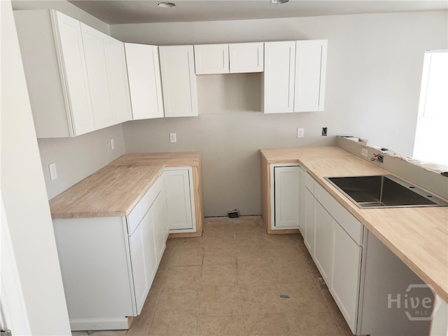 306 Connor Ct, Hinesville, GA 31313 - kitchen with white cabinetry and light tile patterned floors