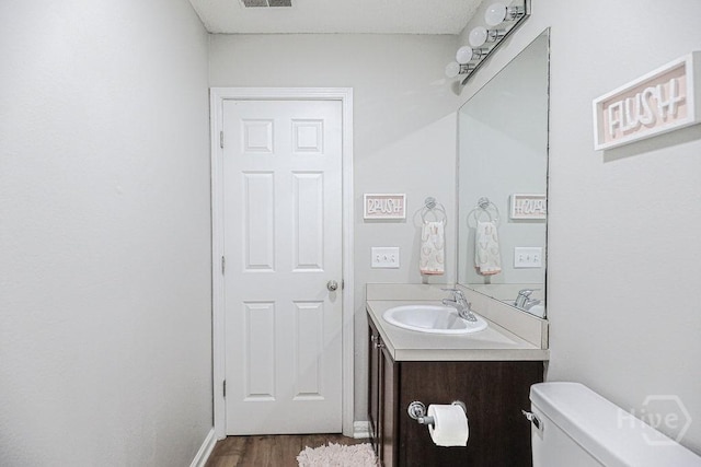 1125 Canyon Oak Loop, Richmond Hill, GA 31324 - half bathroom with vanity and wood finished floors