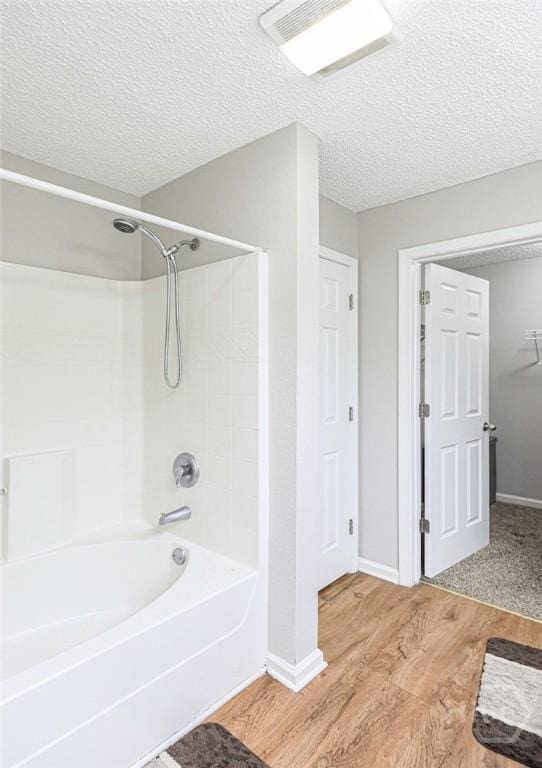 1125 Canyon Oak Loop, Richmond Hill, GA 31324 - full bath featuring shower / washtub combination, wood finished floors, and a textured ceiling
