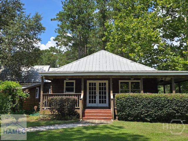 485 Lake Pamona Rd, Midway, GA 31320 - view of front of house featuring covered porch, french doors, a front lawn, a metal roof, and a ceiling fan