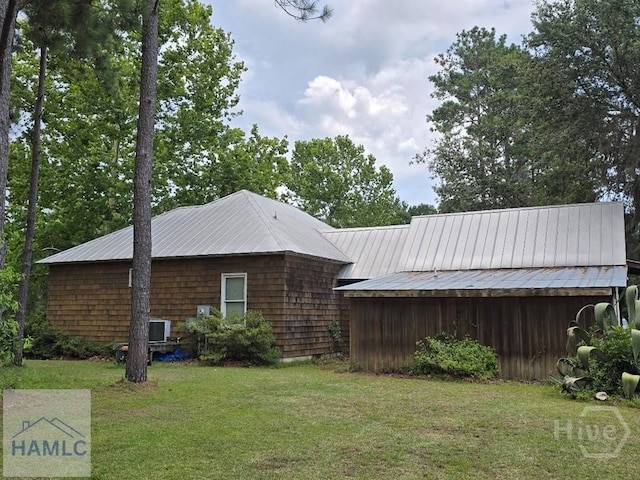 485 Lake Pamona Rd, Midway, GA 31320 - view of side of property with a lawn and a metal roof