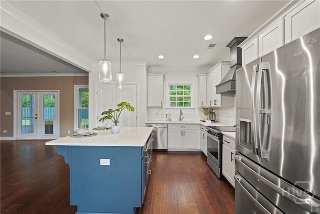 95 Simcoe Lake Dr, Richmond Hill, GA 31324 - kitchen with appliances with stainless steel finishes, blue cabinets, ornamental molding, white cabinetry, and a kitchen bar