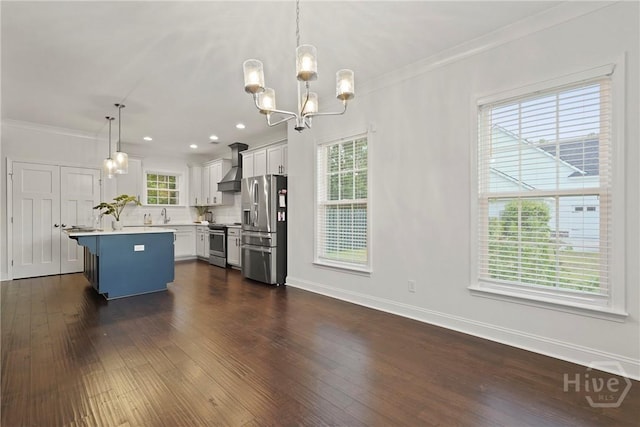 95 Simcoe Lake Dr, Richmond Hill, GA 31324 - kitchen featuring stainless steel appliances, wall chimney exhaust hood, light countertops, a chandelier, and dark wood-type flooring