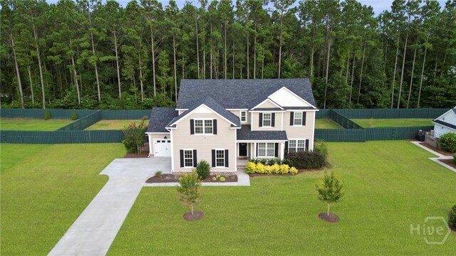 95 Simcoe Lake Dr, Richmond Hill, GA 31324 - traditional home with a garage, driveway, and a fenced backyard