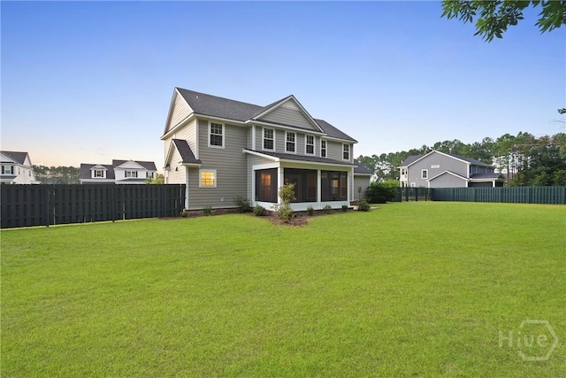 95 Simcoe Lake Dr, Richmond Hill, GA 31324 - back of house with a fenced backyard and a sunroom
