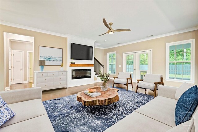 95 Simcoe Lake Dr, Richmond Hill, GA 31324 - living area with crown molding, a ceiling fan, wood finished floors, and a glass covered fireplace