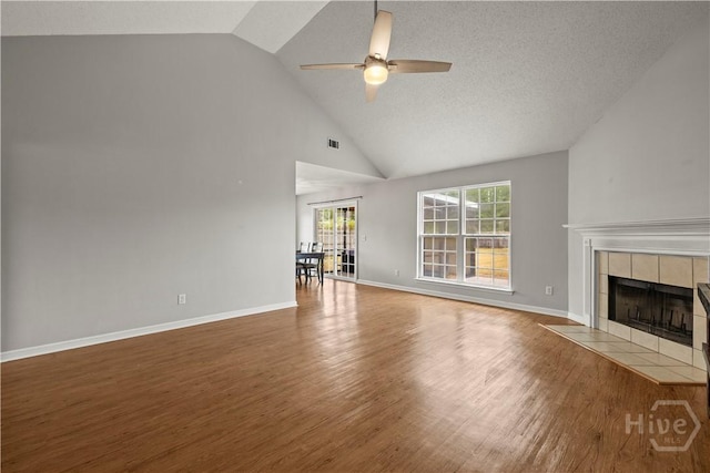 226 Cyane Ln, Guyton, GA 31312 - unfurnished living room with a fireplace, ceiling fan, wood finished floors, and high vaulted ceiling