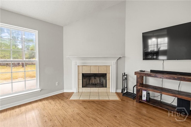 226 Cyane Ln, Guyton, GA 31312 - unfurnished living room with wood finished floors and a tiled fireplace
