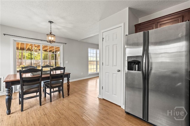 226 Cyane Ln, Guyton, GA 31312 - dining area with light wood-style flooring, a textured ceiling, and a chandelier
