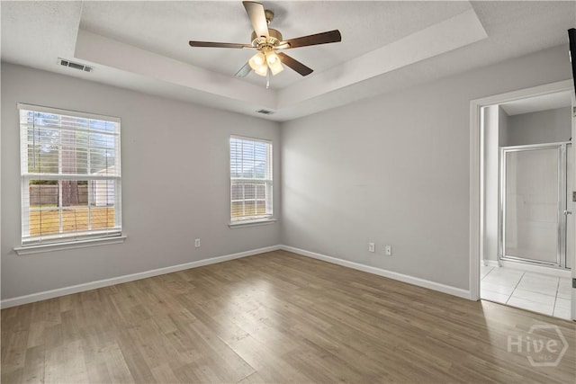 226 Cyane Ln, Guyton, GA 31312 - unfurnished room featuring a tray ceiling, light wood-style floors, and a ceiling fan