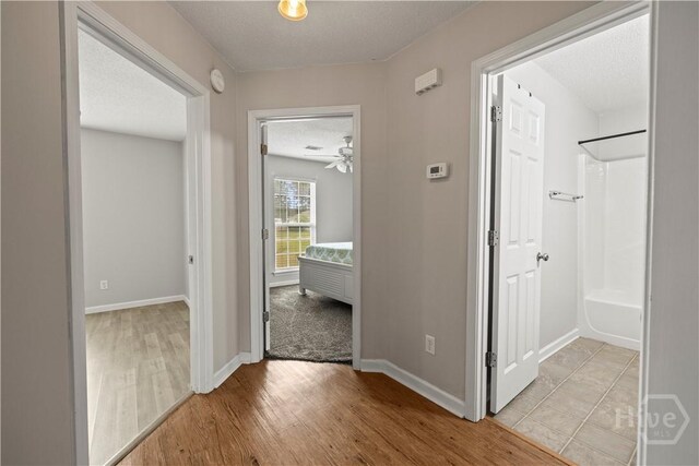 226 Cyane Ln, Guyton, GA 31312 - hallway featuring light wood-style flooring and a textured ceiling