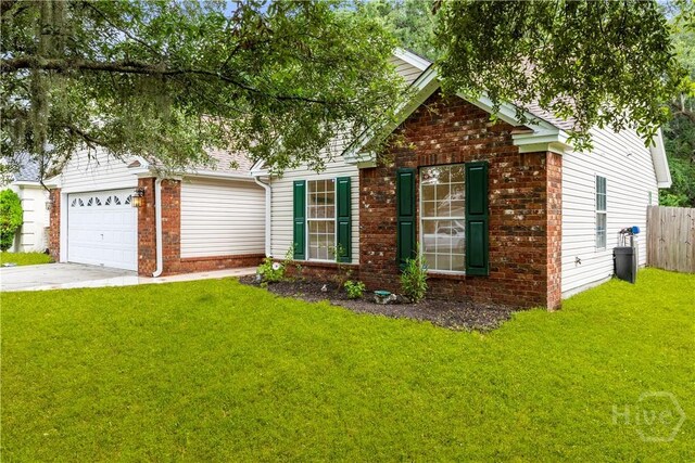 259 Laurel Hill Cir, Richmond Hill, GA 31324 - obstructed view of property with brick siding, concrete driveway, and a garage