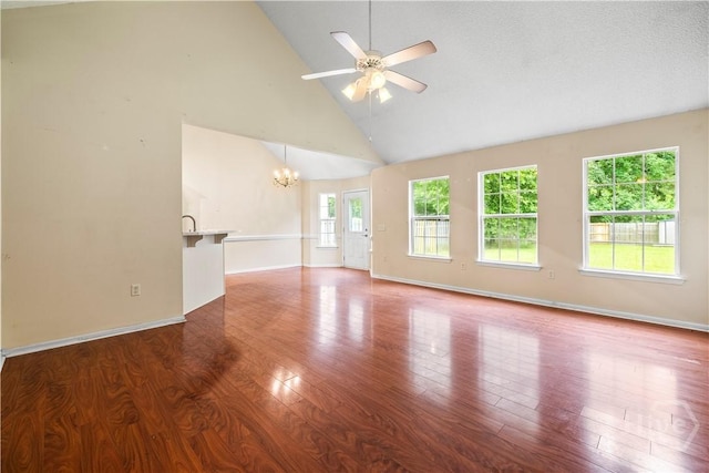 259 Laurel Hill Cir, Richmond Hill, GA 31324 - unfurnished living room featuring a chandelier, high vaulted ceiling, a ceiling fan, and wood finished floors