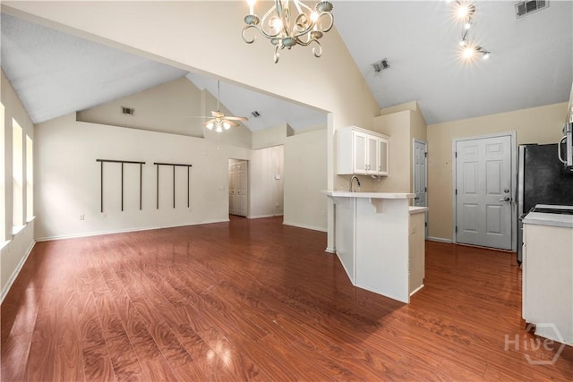 259 Laurel Hill Cir, Richmond Hill, GA 31324 - kitchen with light countertops, white cabinetry, dark wood-style flooring, a breakfast bar, and high vaulted ceiling