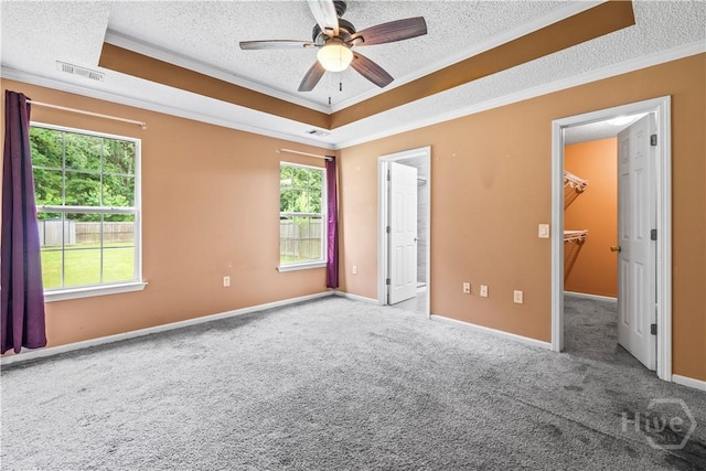 259 Laurel Hill Cir, Richmond Hill, GA 31324 - unfurnished bedroom with a textured ceiling, a spacious closet, crown molding, multiple windows, and carpet floors