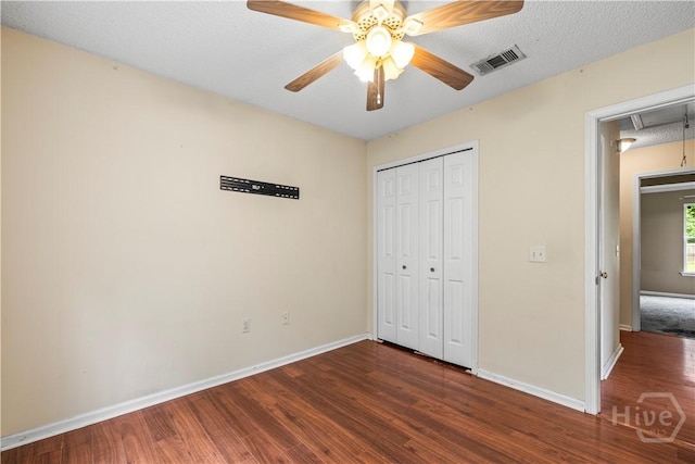 259 Laurel Hill Cir, Richmond Hill, GA 31324 - unfurnished bedroom featuring attic access, wood finished floors, a closet, and a ceiling fan
