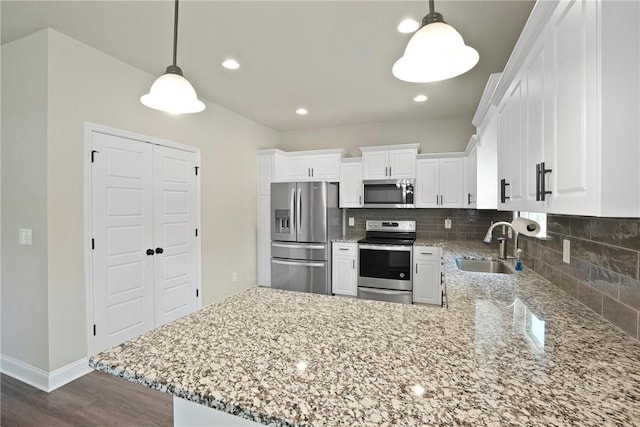 328 Providence Trce, Statesboro, GA 30461 - kitchen with stainless steel appliances, decorative backsplash, white cabinetry, a peninsula, and recessed lighting