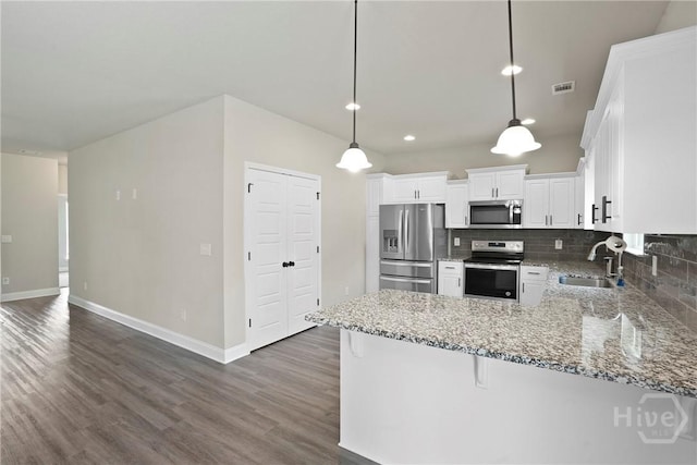 328 Providence Trce, Statesboro, GA 30461 - kitchen with stainless steel appliances, dark wood-style flooring, light stone counters, tasteful backsplash, and white cabinets