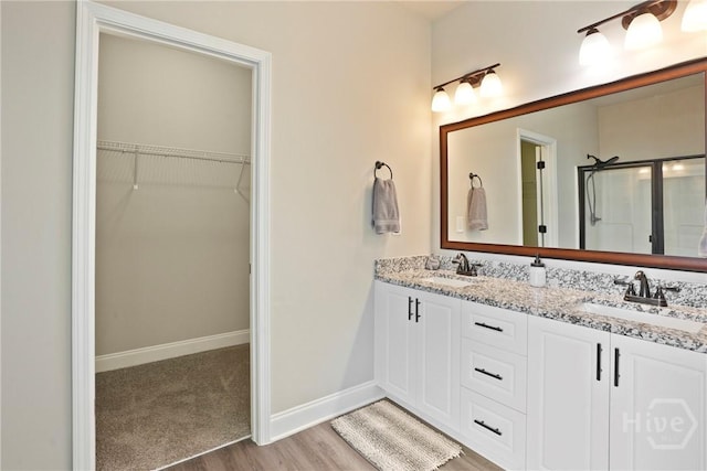 328 Providence Trce, Statesboro, GA 30461 - full bathroom with wood finished floors, double vanity, a stall shower, and a spacious closet