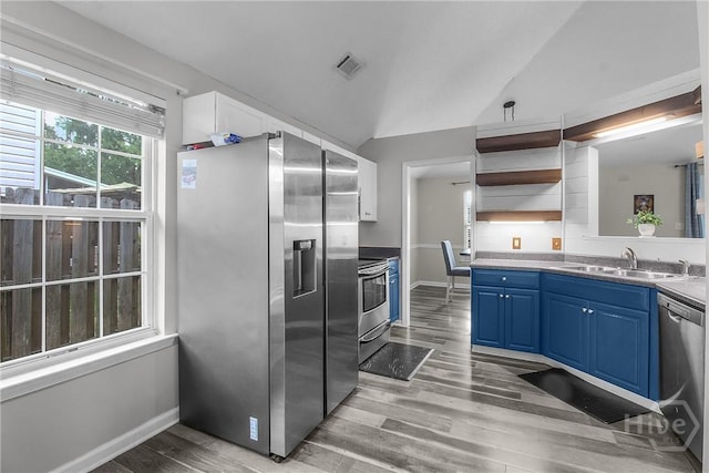 175 Salt Landing Cir, Savannah, GA 31405 - kitchen with stainless steel appliances, blue cabinets, open shelves, light wood-style floors, and vaulted ceiling