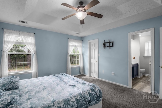 175 Salt Landing Cir, Savannah, GA 31405 - carpeted bedroom featuring ensuite bath, a textured ceiling, and a ceiling fan