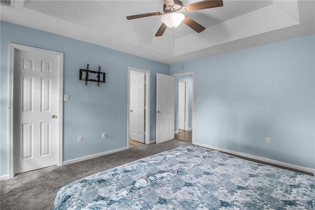 175 Salt Landing Cir, Savannah, GA 31405 - unfurnished bedroom featuring carpet, a tray ceiling, a ceiling fan, and a textured ceiling