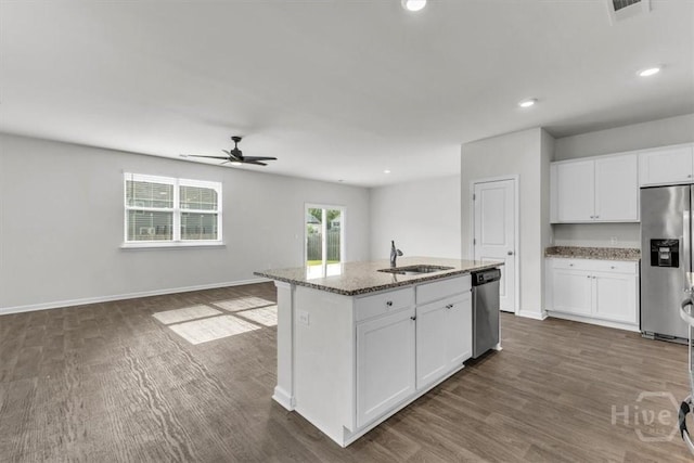 338 Wedge Cir, Richmond Hill, GA 31324 - kitchen with stainless steel appliances, a ceiling fan, light stone countertops, dark wood finished floors, and white cabinetry