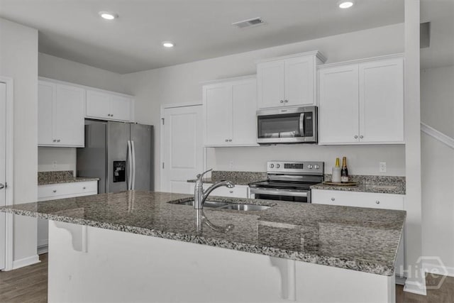 338 Wedge Cir, Richmond Hill, GA 31324 - kitchen with appliances with stainless steel finishes, white cabinetry, dark wood-type flooring, and recessed lighting