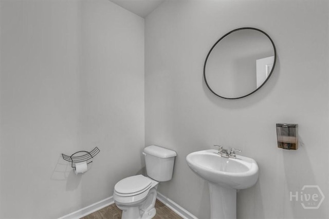 338 Wedge Cir, Richmond Hill, GA 31324 - half bath with wood finished floors and toilet