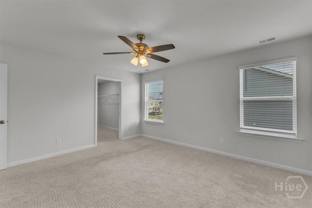 338 Wedge Cir, Richmond Hill, GA 31324 - unfurnished bedroom featuring light colored carpet, a spacious closet, and a ceiling fan
