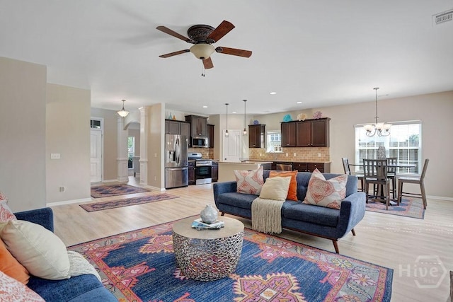 208 Chippingwood Cir, Pooler, GA 31322 - living room featuring light wood-style floors, a ceiling fan, a chandelier, and recessed lighting