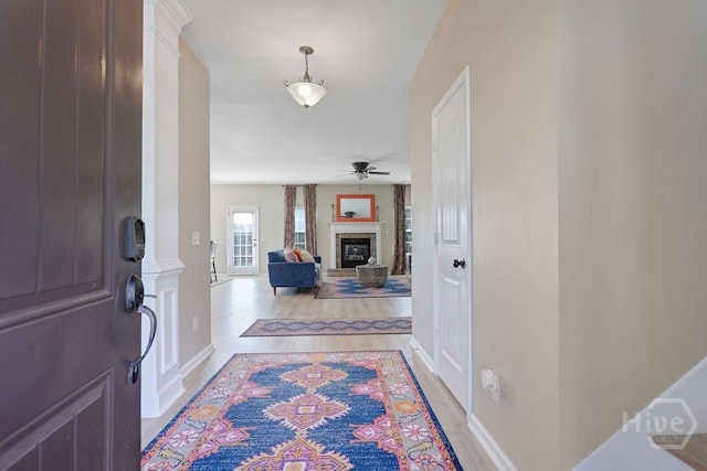 208 Chippingwood Cir, Pooler, GA 31322 - foyer with light wood-style floors, a glass covered fireplace, and a ceiling fan