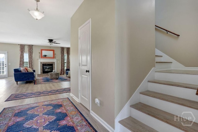 208 Chippingwood Cir, Pooler, GA 31322 - staircase with ceiling fan, wood finished floors, and a brick fireplace