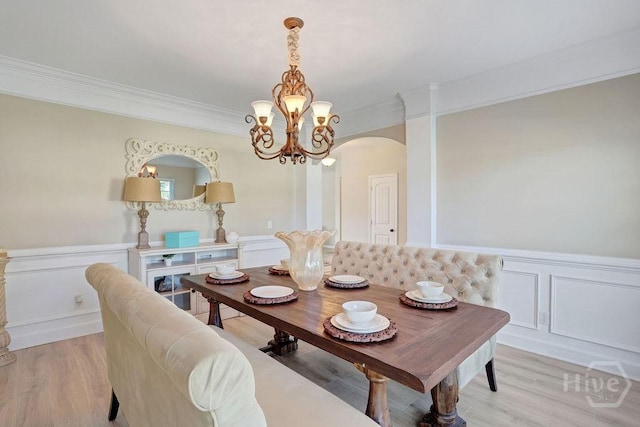 208 Chippingwood Cir, Pooler, GA 31322 - dining space with arched walkways, ornamental molding, a chandelier, light wood-type flooring, and a wainscoted wall
