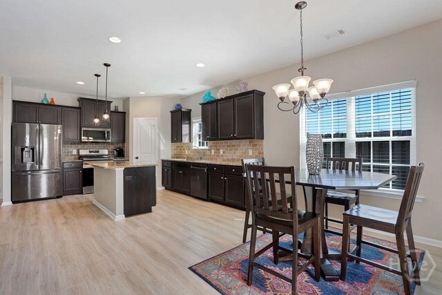 208 Chippingwood Cir, Pooler, GA 31322 - kitchen featuring stainless steel appliances, healthy amount of natural light, a chandelier, backsplash, and recessed lighting