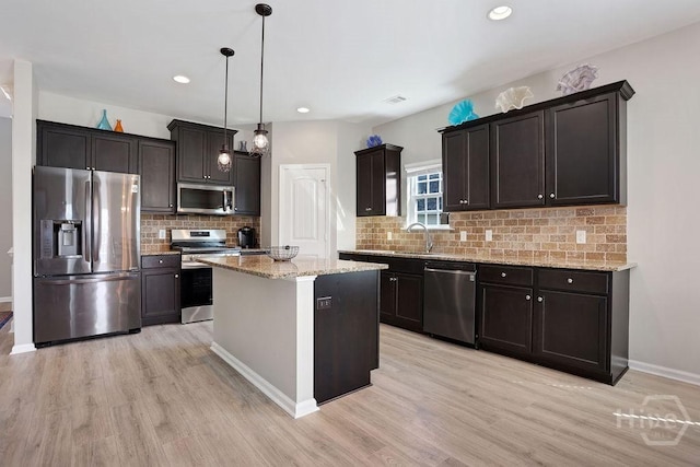 208 Chippingwood Cir, Pooler, GA 31322 - kitchen featuring appliances with stainless steel finishes, light wood finished floors, light stone counters, recessed lighting, and tasteful backsplash