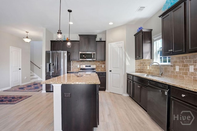 208 Chippingwood Cir, Pooler, GA 31322 - kitchen with stainless steel appliances, light wood-style floors, a kitchen island, dark brown cabinets, and recessed lighting