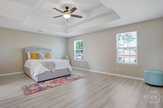 208 Chippingwood Cir, Pooler, GA 31322 - bedroom with a tray ceiling, wood finished floors, multiple windows, and ceiling fan