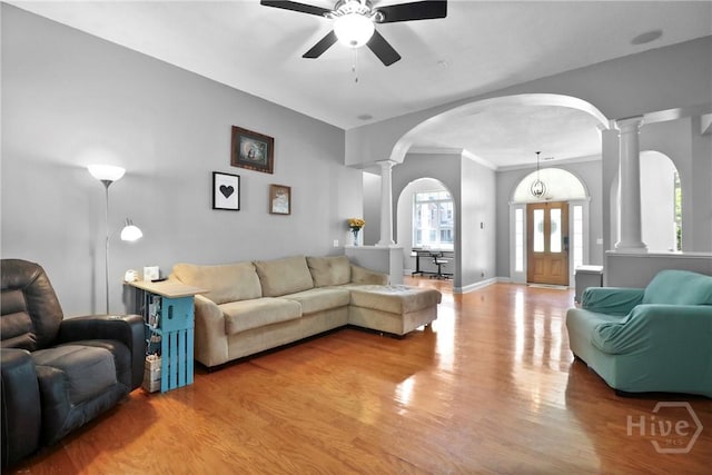 204 Bristol Way, Richmond Hill, GA 31324 - living area featuring arched walkways, decorative columns, ceiling fan, wood finished floors, and ornamental molding
