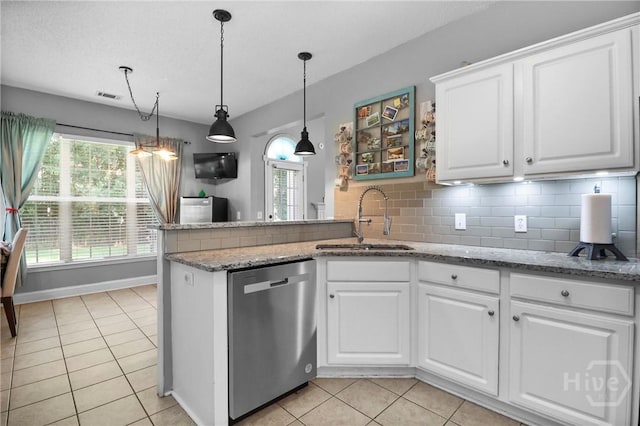 204 Bristol Way, Richmond Hill, GA 31324 - kitchen featuring stainless steel dishwasher, light tile patterned floors, white cabinets, and tasteful backsplash