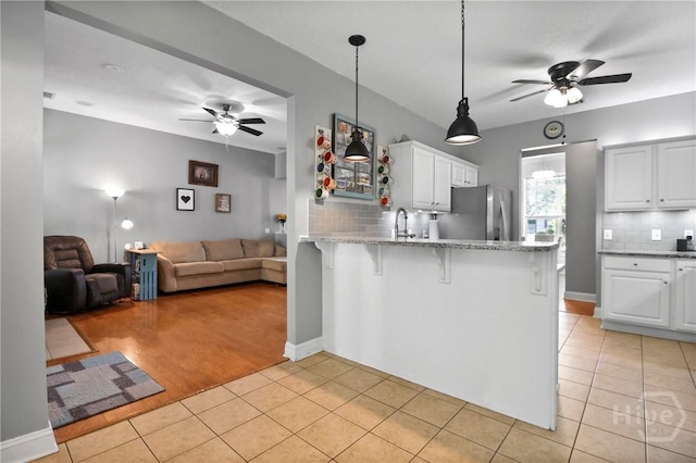 204 Bristol Way, Richmond Hill, GA 31324 - kitchen with a ceiling fan, freestanding refrigerator, light tile patterned floors, and a peninsula