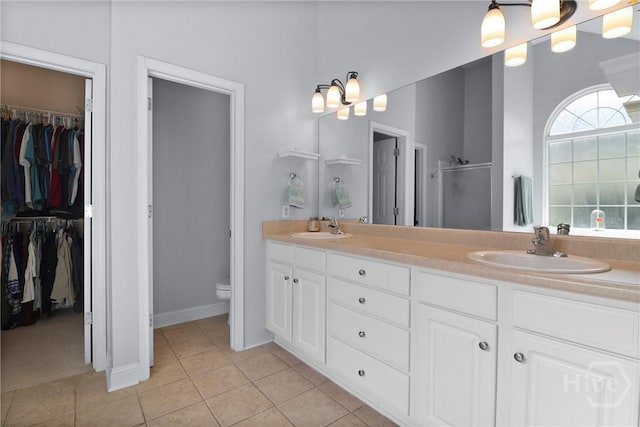 204 Bristol Way, Richmond Hill, GA 31324 - bathroom with double vanity, tile patterned flooring, a spacious closet, and a stall shower