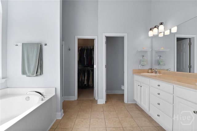 204 Bristol Way, Richmond Hill, GA 31324 - full bathroom featuring double vanity, a garden tub, tile patterned flooring, and a spacious closet